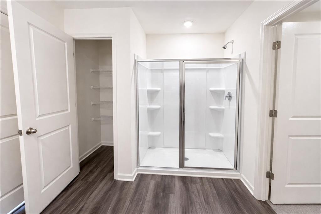 44 Rowlett Place Winder, GA 30680 - Photo 20 of 47 a bathroom with a glass shower door