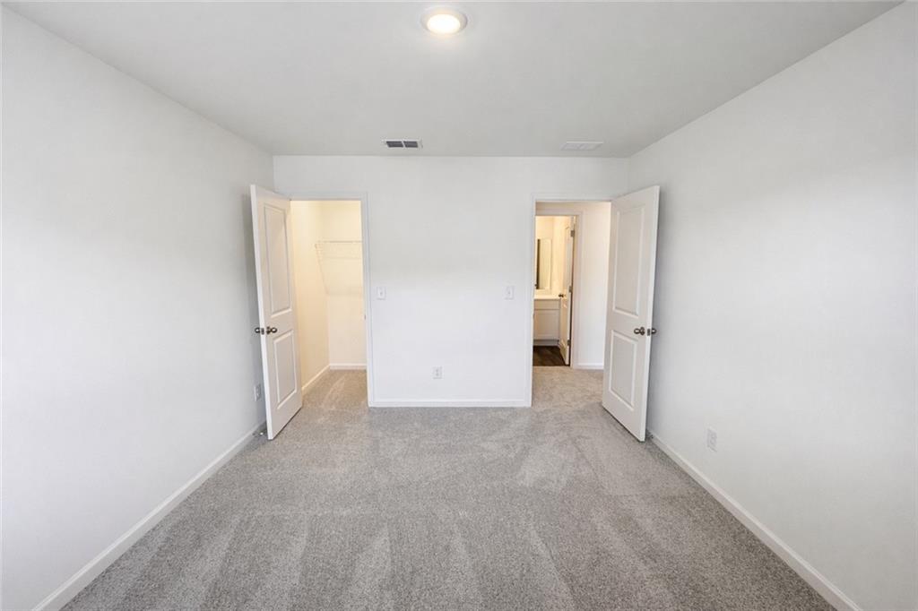 44 Rowlett Place Winder, GA 30680 - Photo 29 of 47 an empty room with windows and closet