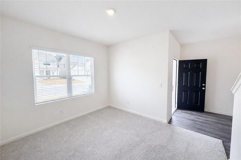 44 Rowlett Place Winder, GA 30680 - Photo 3 of 47 a view of an empty room with closet and a window
