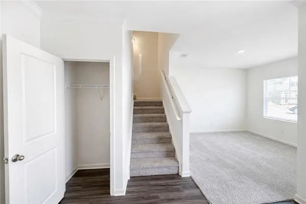 a view of a hallway with wooden floor and entryway
