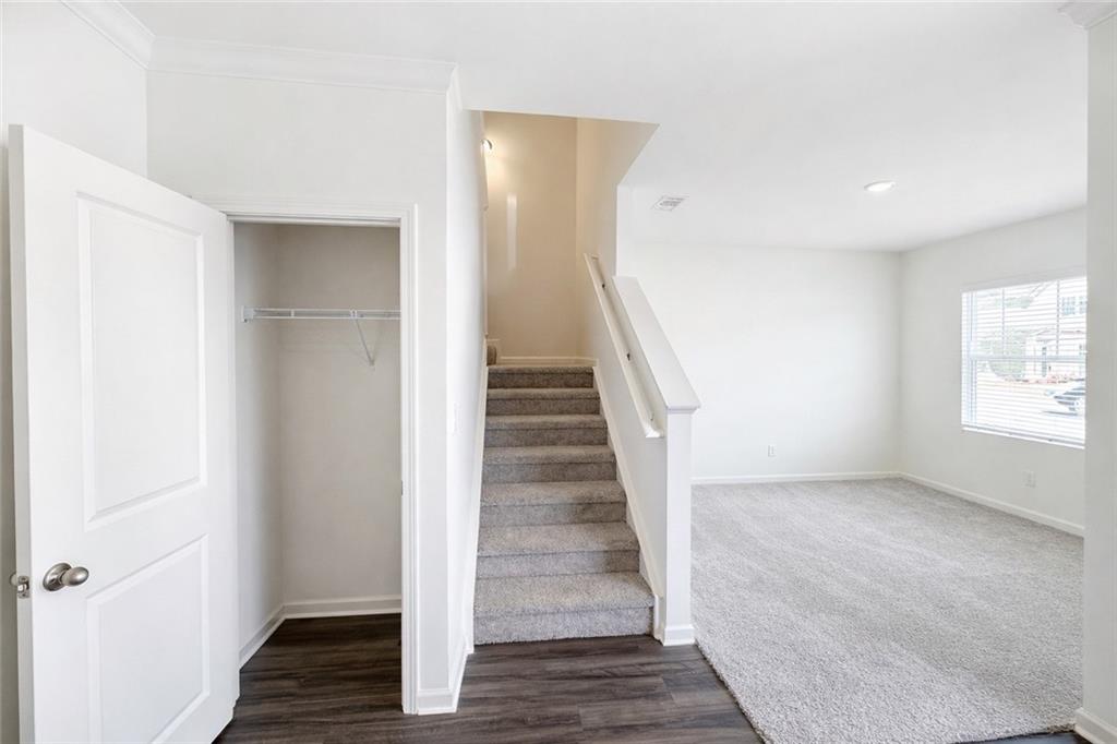 44 Rowlett Place Winder, GA 30680 - Photo 4 of 47 a view of a hallway with wooden floor and entryway