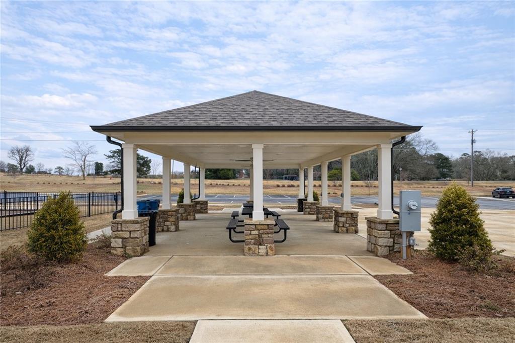 44 Rowlett Place Winder, GA 30680 - Photo 41 of 47 a view of a patio with couches and table and chairs under an umbrella