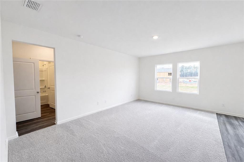 44 Rowlett Place Winder, GA 30680 - Photo 9 of 47 an empty room with windows and closet