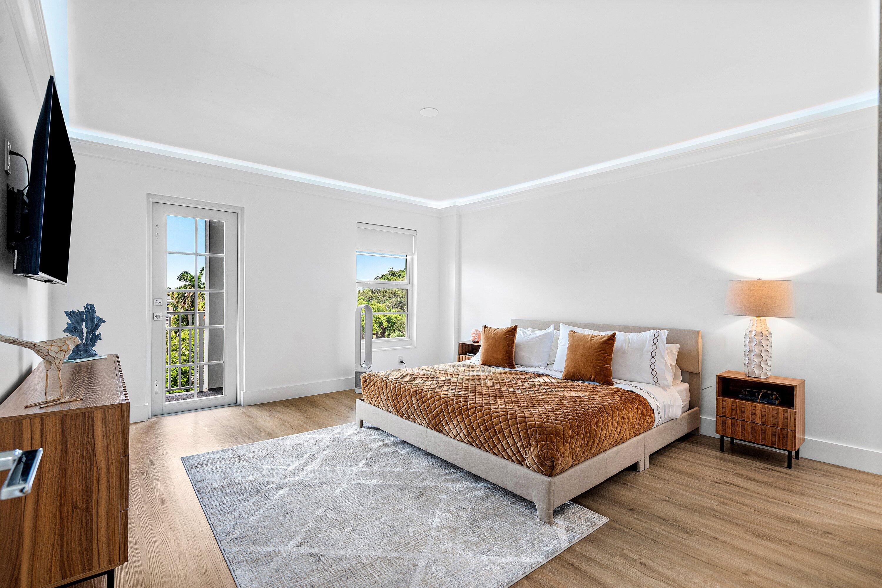 1111 South Ocean Boulevard, Unit 4210 Boca Raton, FL 33432 - Photo 12 of 28 a bedroom with a bed and a flat screen tv