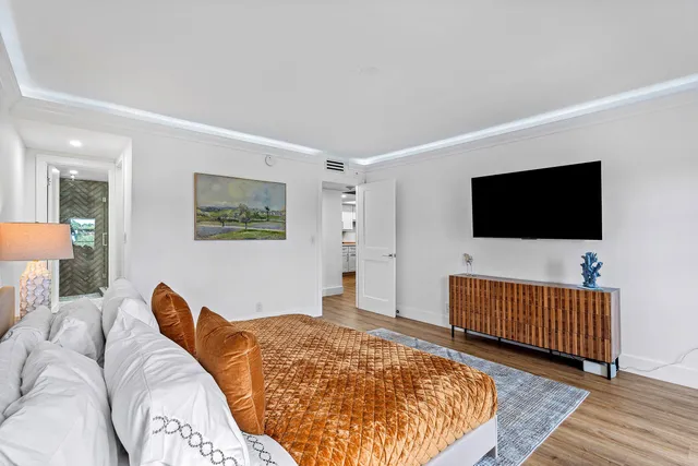 a bedroom with a bed and a flat screen tv