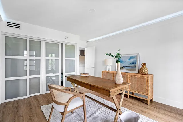 a living room with a table and chairs