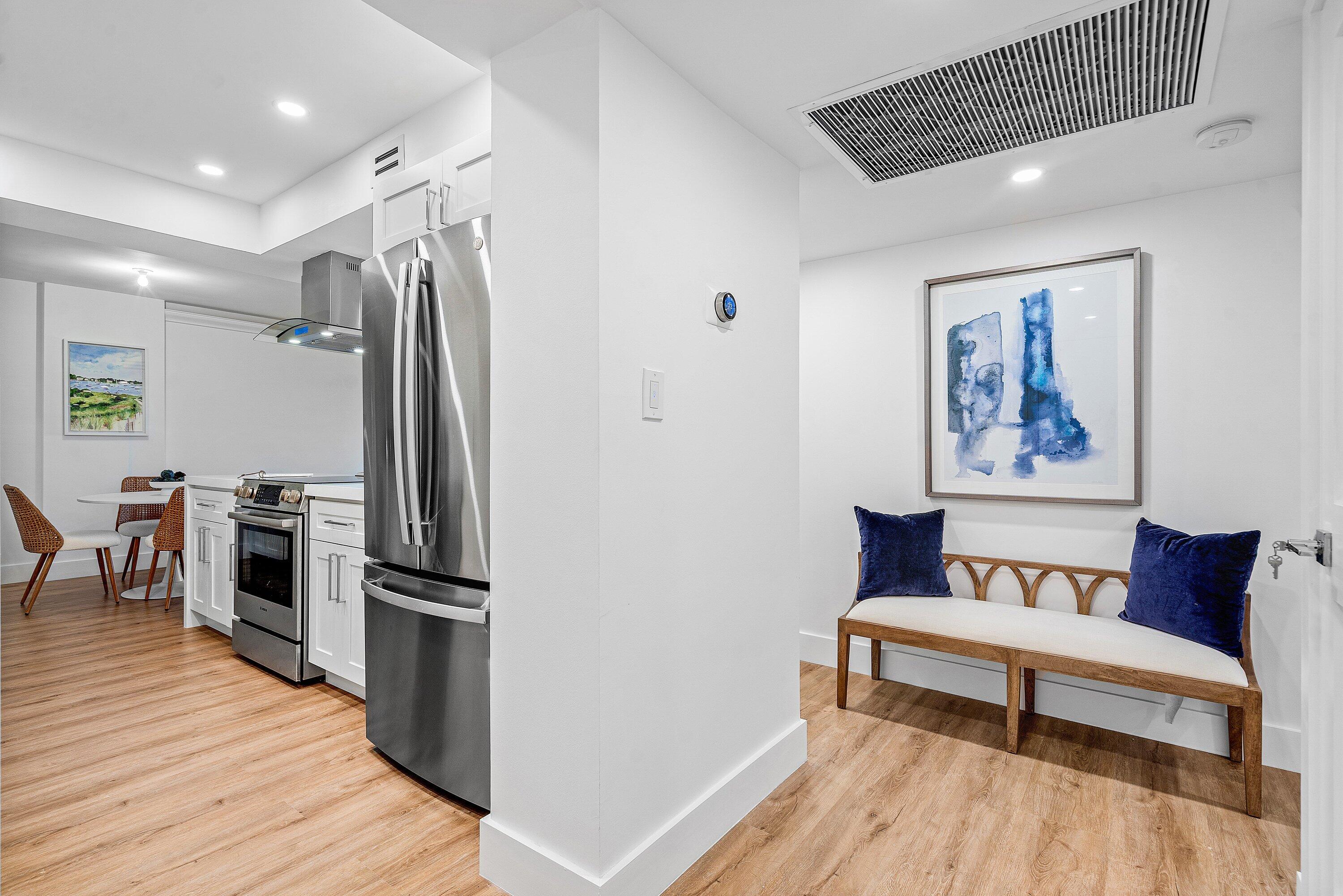 1111 South Ocean Boulevard, Unit 4210 Boca Raton, FL 33432 - Photo 2 of 28 a view of a hallway with wooden floor and furniture