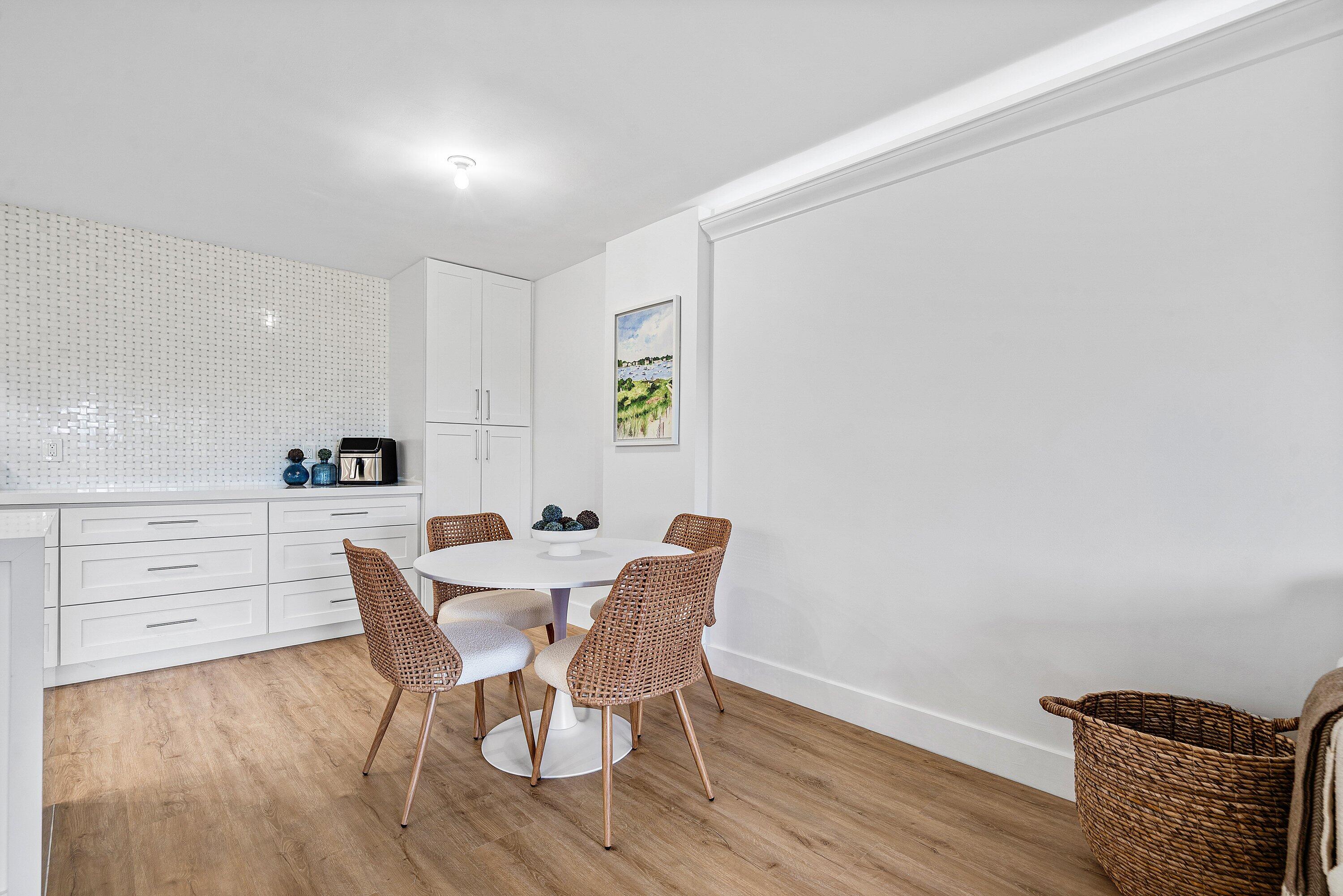 1111 South Ocean Boulevard, Unit 4210 Boca Raton, FL 33432 - Photo 5 of 28 a view of a dining room with furniture and wooden floor