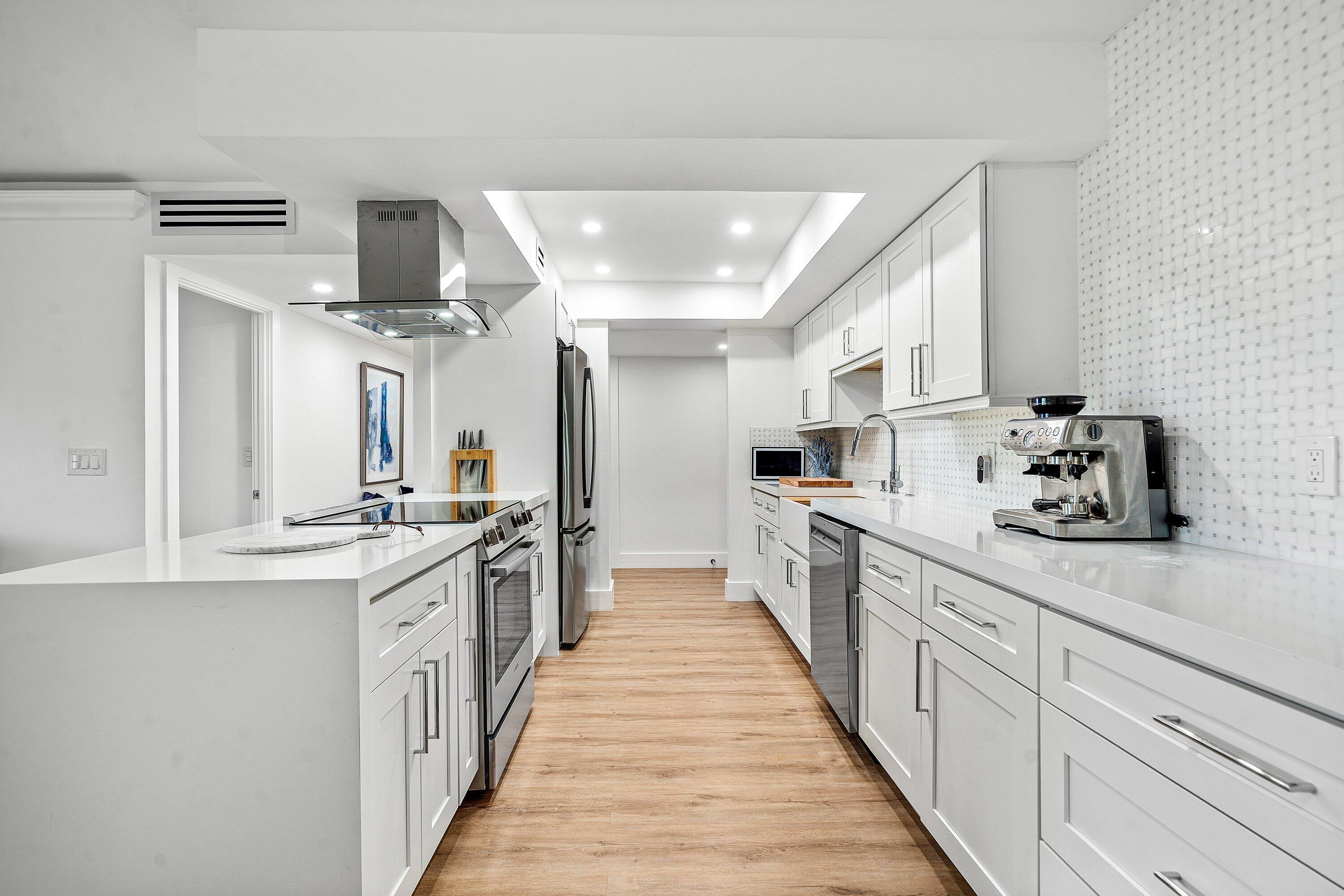 1111 South Ocean Boulevard, Unit 4210 Boca Raton, FL 33432 - Photo 6 of 28 a kitchen with stainless steel appliances a sink stove and cabinets