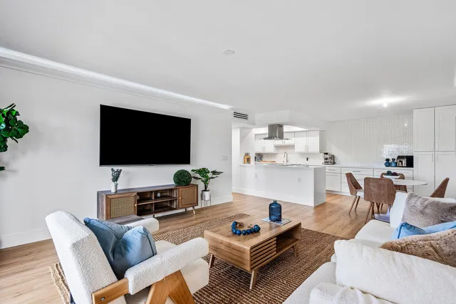 a living room with furniture a rug and a flat screen tv