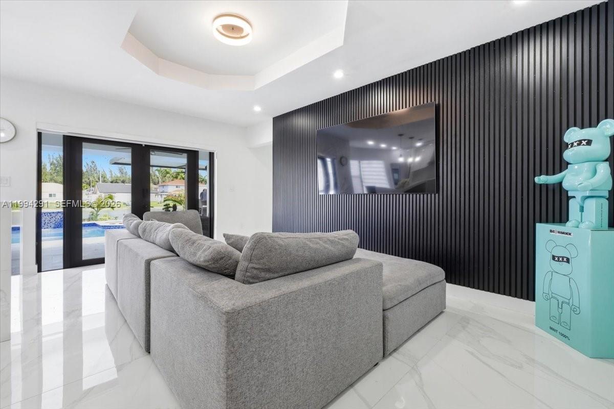 15763 Southwest 43rd Street Miami, FL 33185 - Photo 11 of 46 a living room with furniture and a chandelier