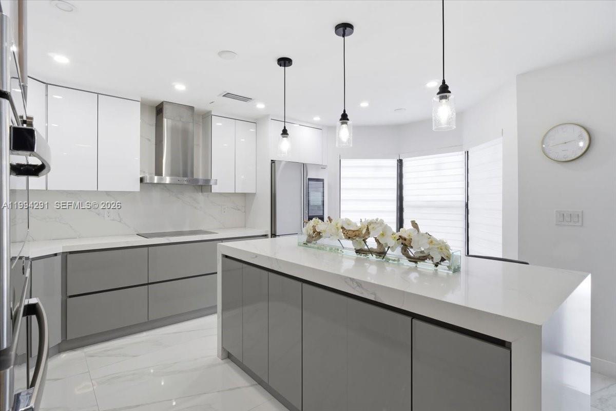 15763 Southwest 43rd Street Miami, FL 33185 - Photo 16 of 46 a kitchen with a sink center island with wooden floor