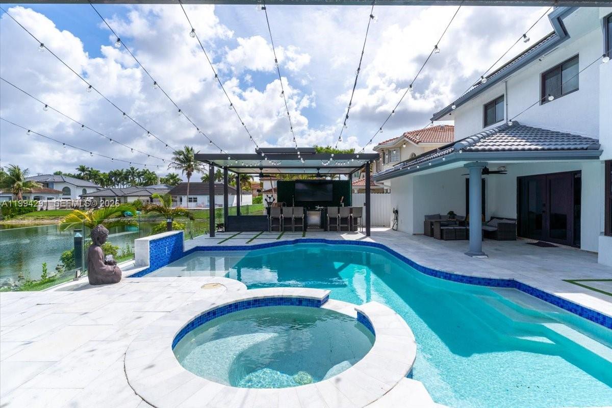 15763 Southwest 43rd Street Miami, FL 33185 - Photo 2 of 46 a view of a swimming pool with a patio
