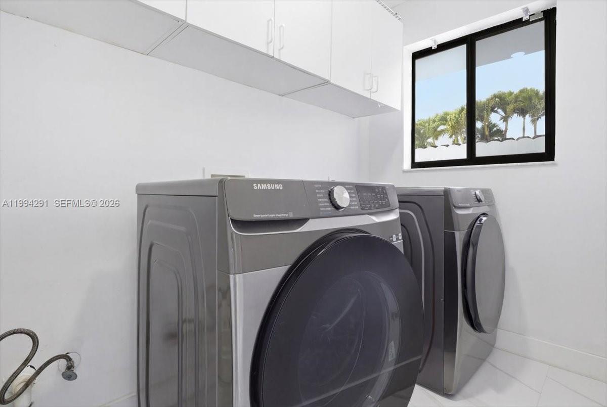 15763 Southwest 43rd Street Miami, FL 33185 - Photo 21 of 46 a utility room with dryer and washer