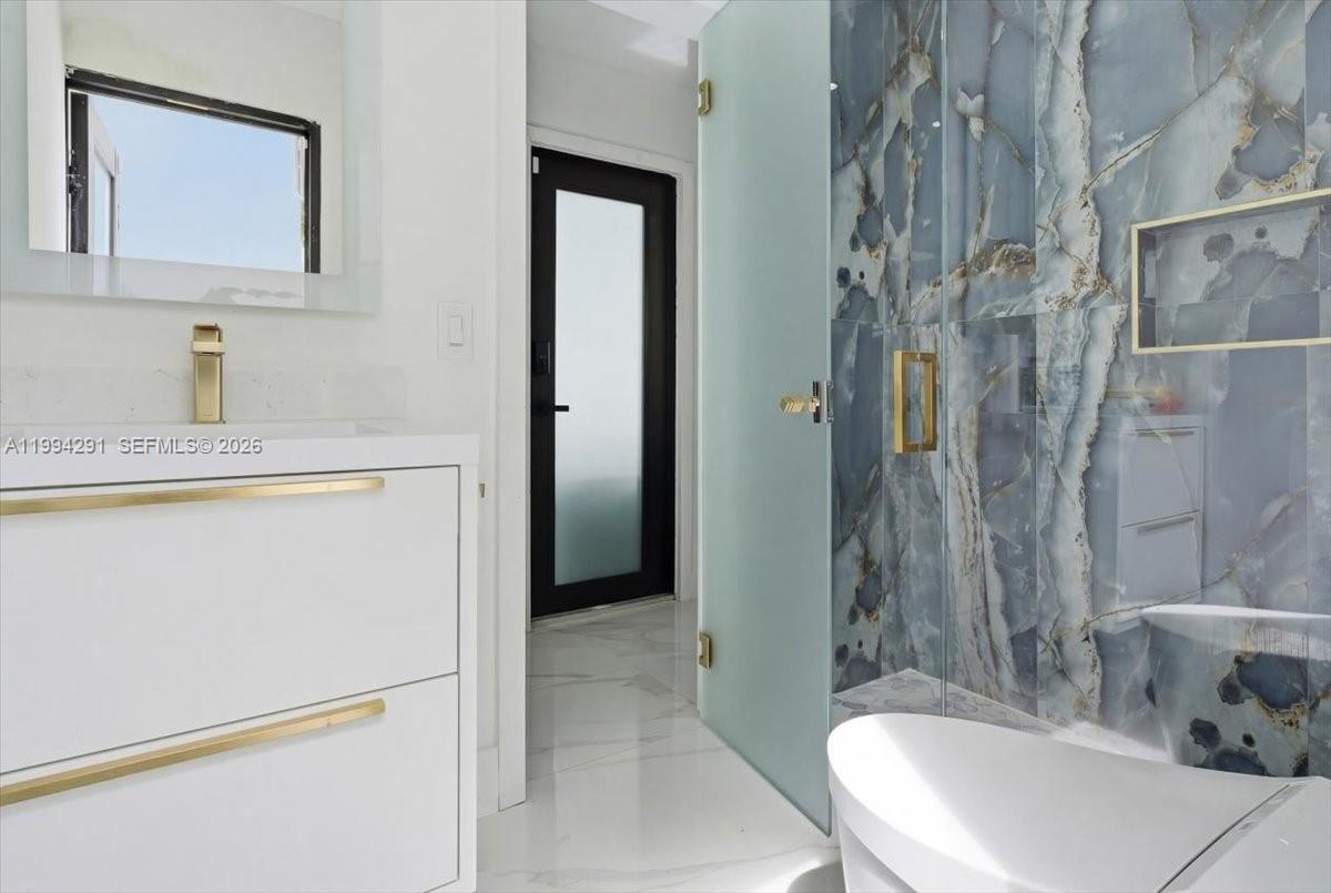 15763 Southwest 43rd Street Miami, FL 33185 - Photo 22 of 46 a bathroom with a sink a toilet and shower