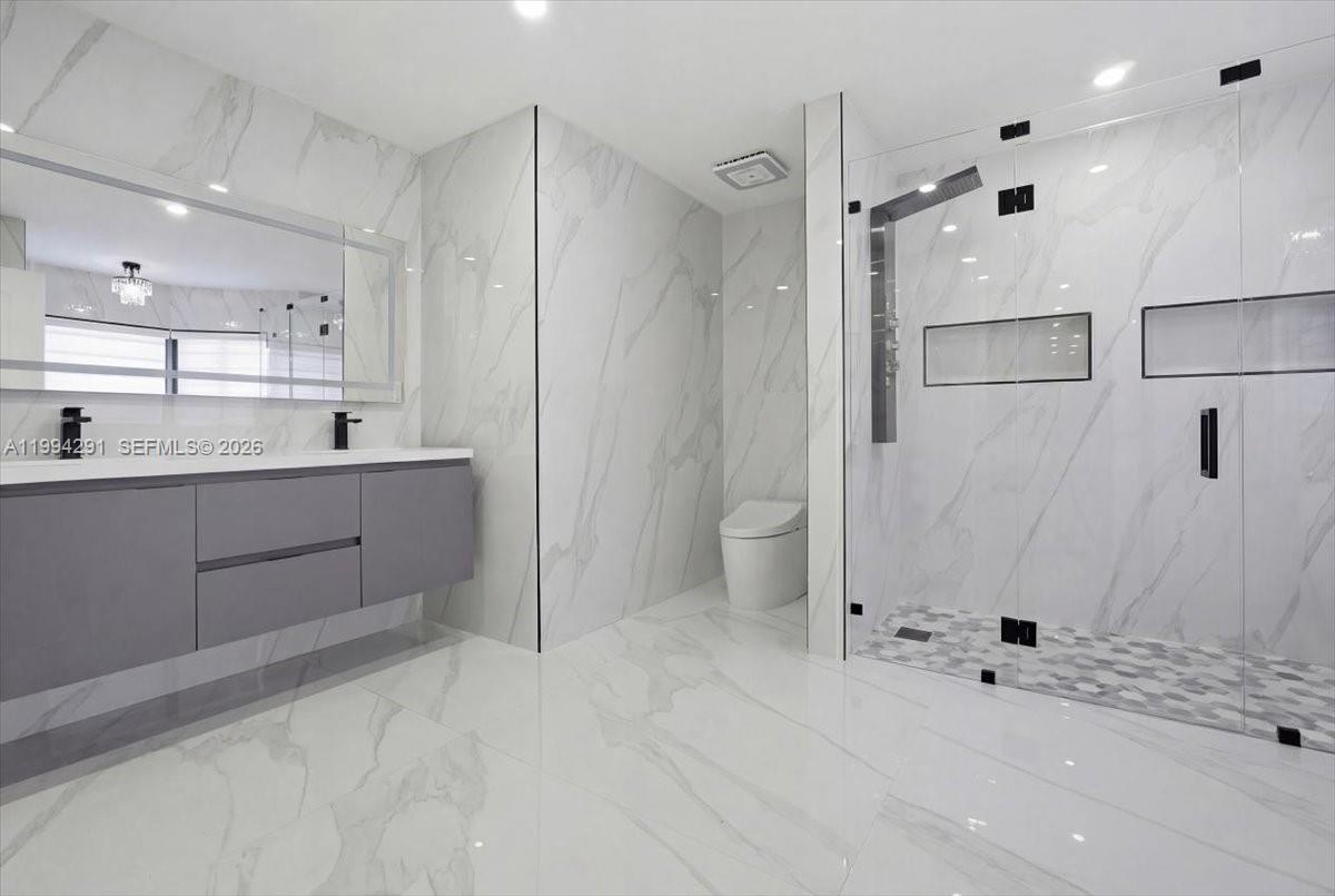 15763 Southwest 43rd Street Miami, FL 33185 - Photo 28 of 46 a bathroom with a granite countertop sink mirror and shower