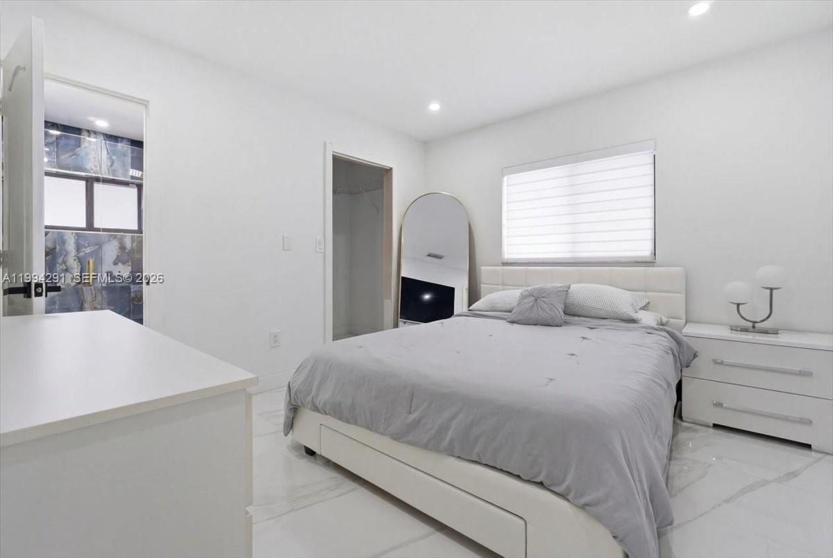 15763 Southwest 43rd Street Miami, FL 33185 - Photo 30 of 46 a spacious bedroom with a bed and a window