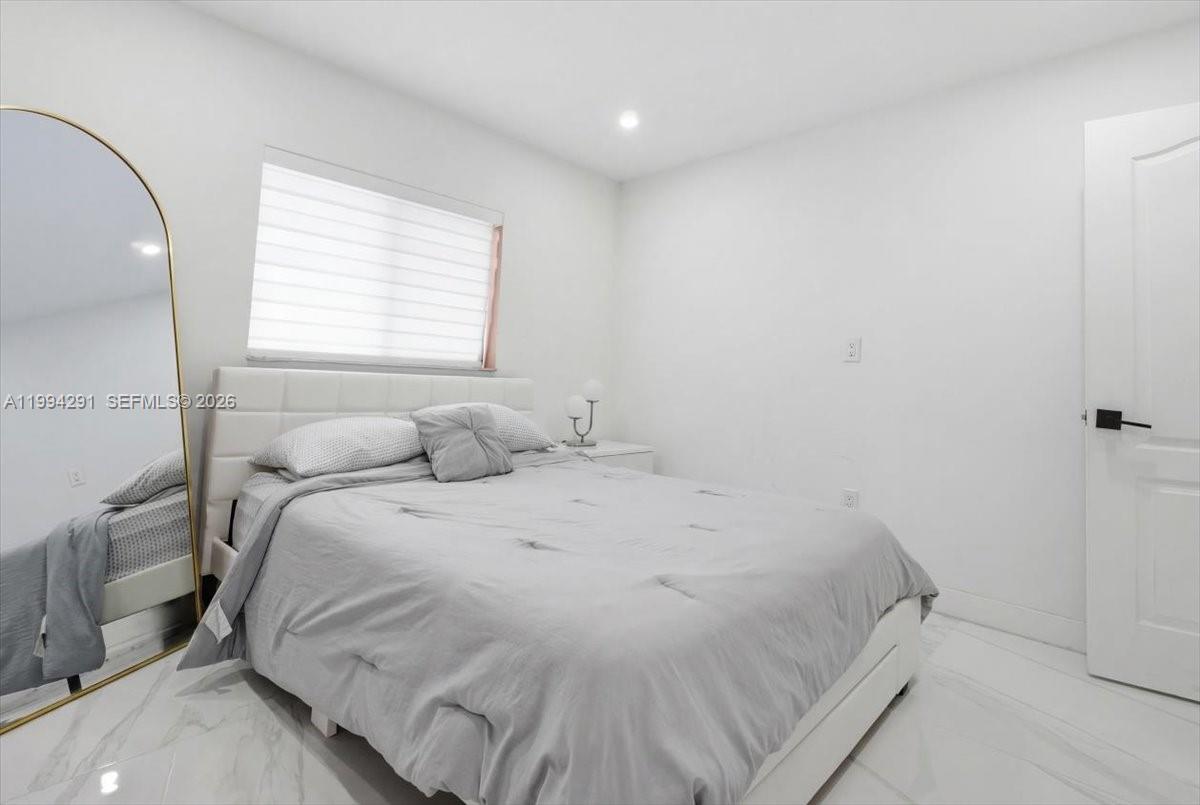 15763 Southwest 43rd Street Miami, FL 33185 - Photo 31 of 46 a bed sitting in a bedroom next to a window