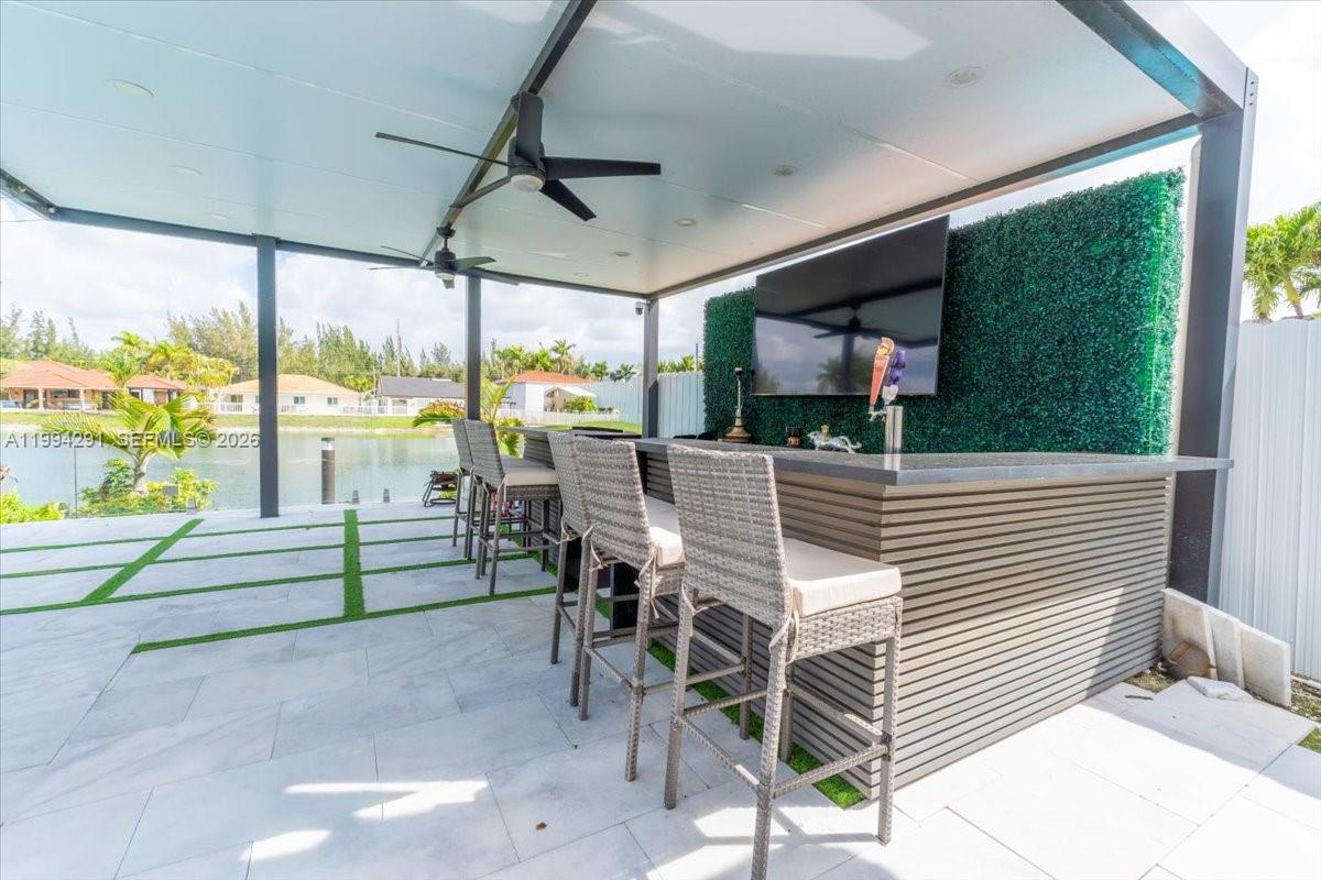 15763 Southwest 43rd Street Miami, FL 33185 - Photo 37 of 46 a view of a patio with a dining table and chairs