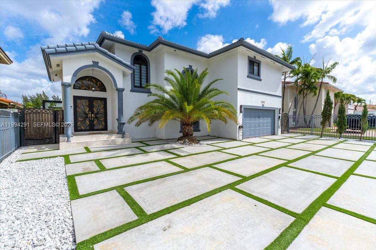 15763 Southwest 43rd Street Miami, FL 33185 - Photo 40 of 46 a view of a house with a sink and a yard with potted plants
