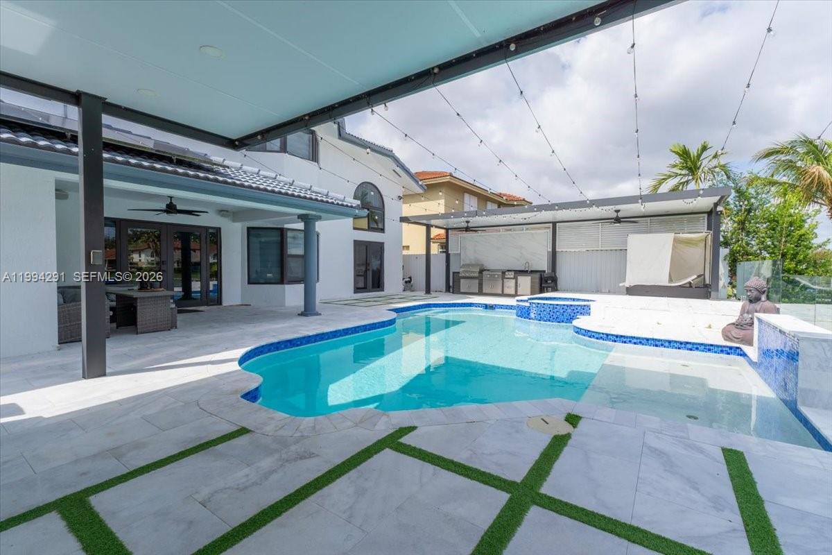 15763 Southwest 43rd Street Miami, FL 33185 - Photo 5 of 46 a swimming pool with outdoor seating and yard