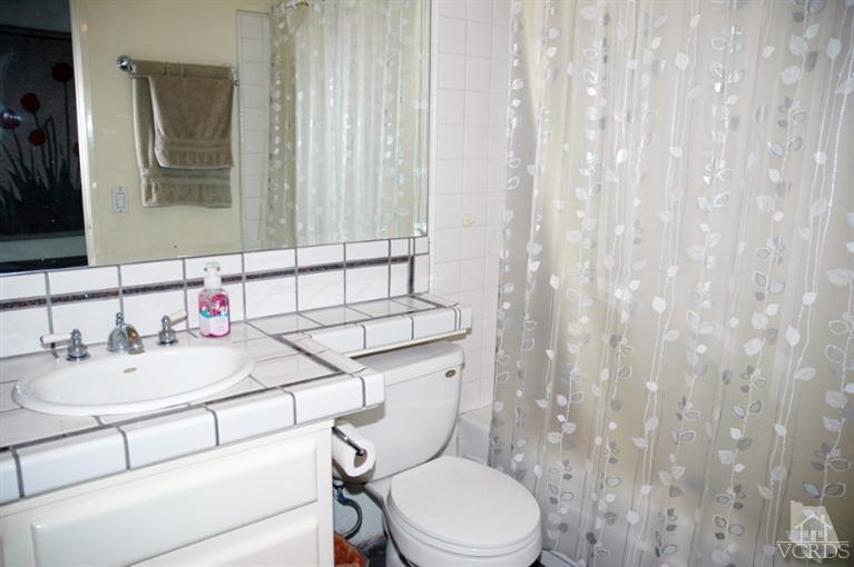 1764 Fitzgerald Road Simi Valley, CA 93065 - Photo 3 of 16 a bathroom with a sink a toilet and shower curtain