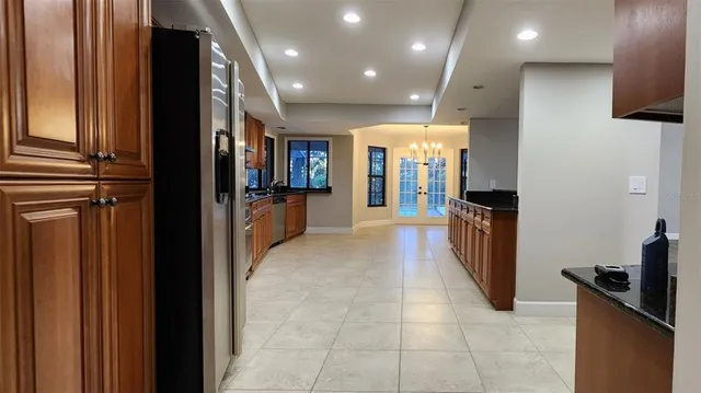 a kitchen with stainless steel appliances granite countertop wooden cabinets a sink and dishwasher