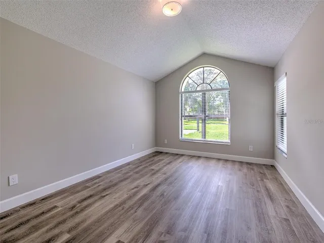 a view of an empty room with glass door