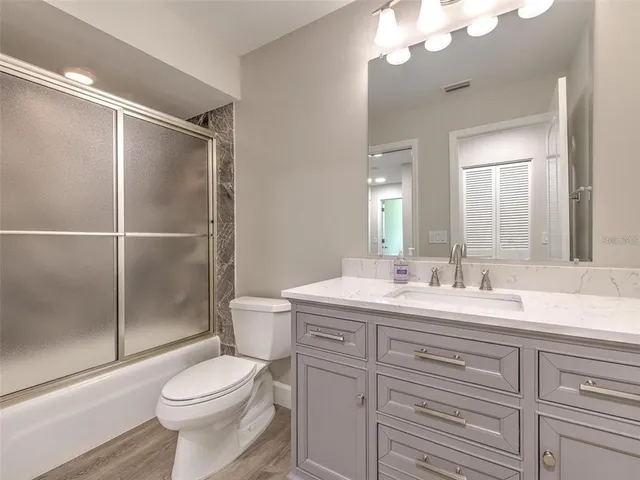a spacious bathroom with a tub shower and sink