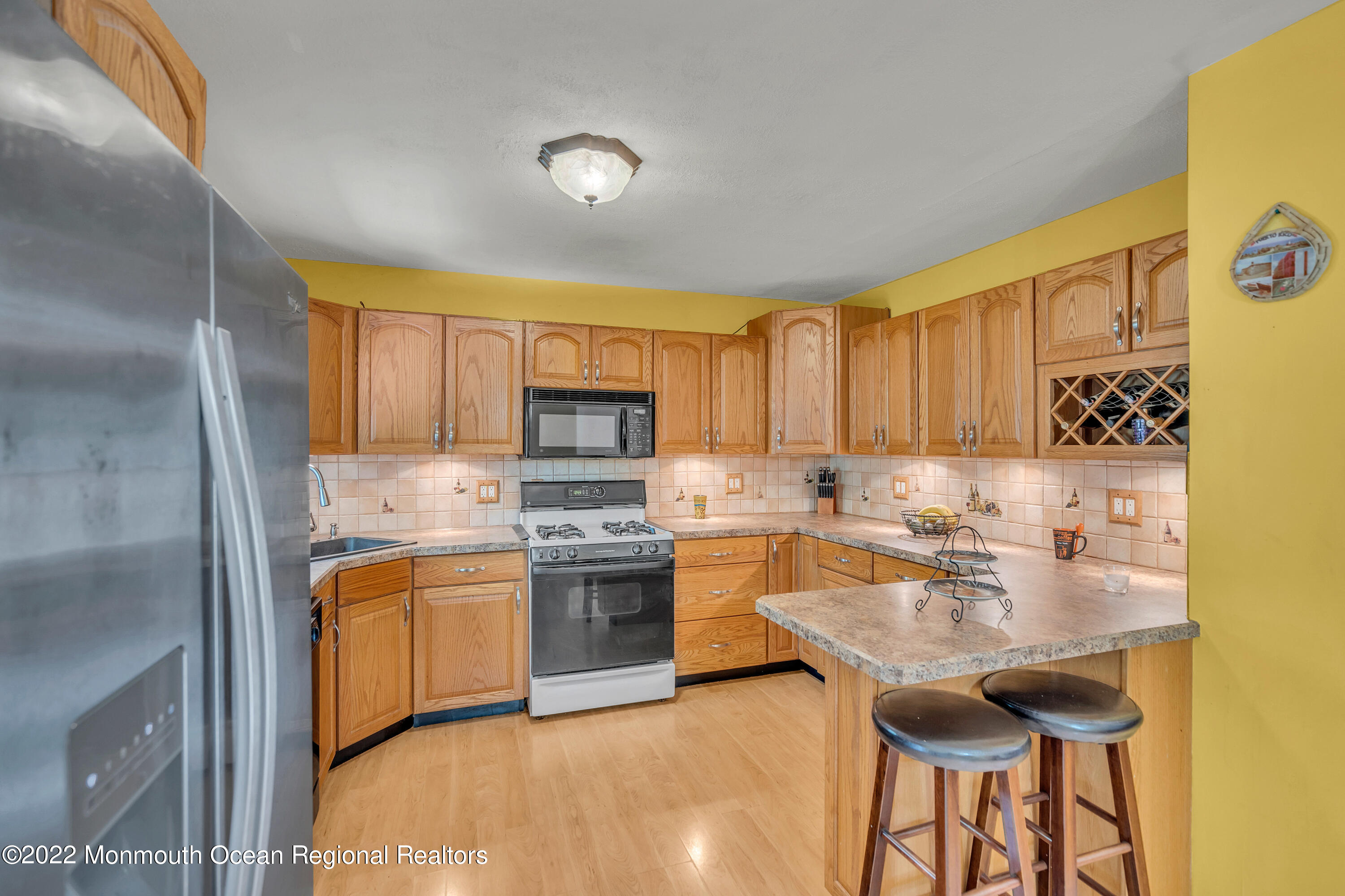148 Weldon Road Manchester Township, NJ 08759 - Photo 17 of 36 a kitchen with stainless steel appliances granite countertop a sink stove and refrigerator