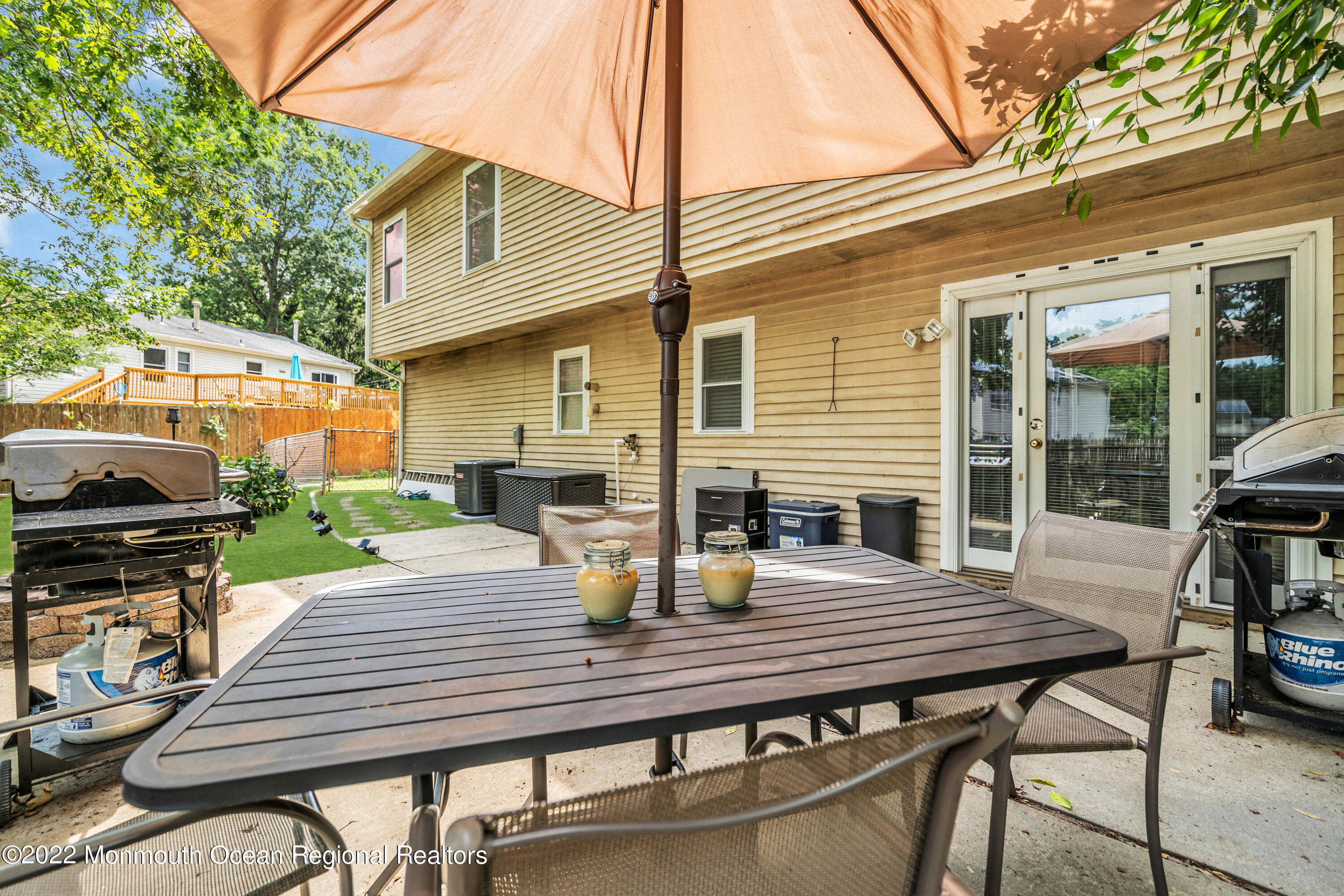 148 Weldon Road Manchester Township, NJ 08759 - Photo 30 of 36 a view of a patio with table and chairs and wooden floor