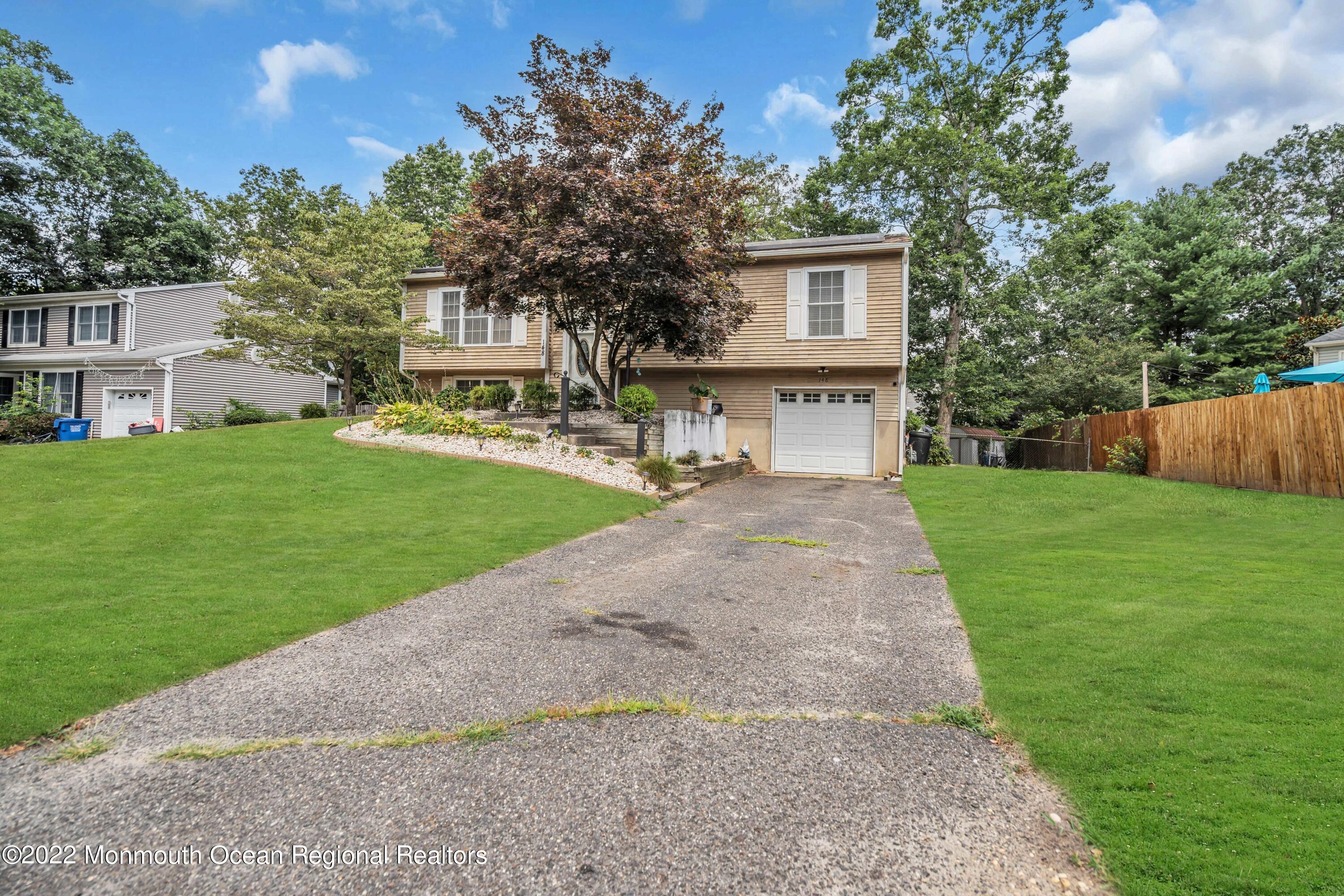 148 Weldon Road Manchester Township, NJ 08759 - Photo 3 of 36 a front view of a house with yard and green space