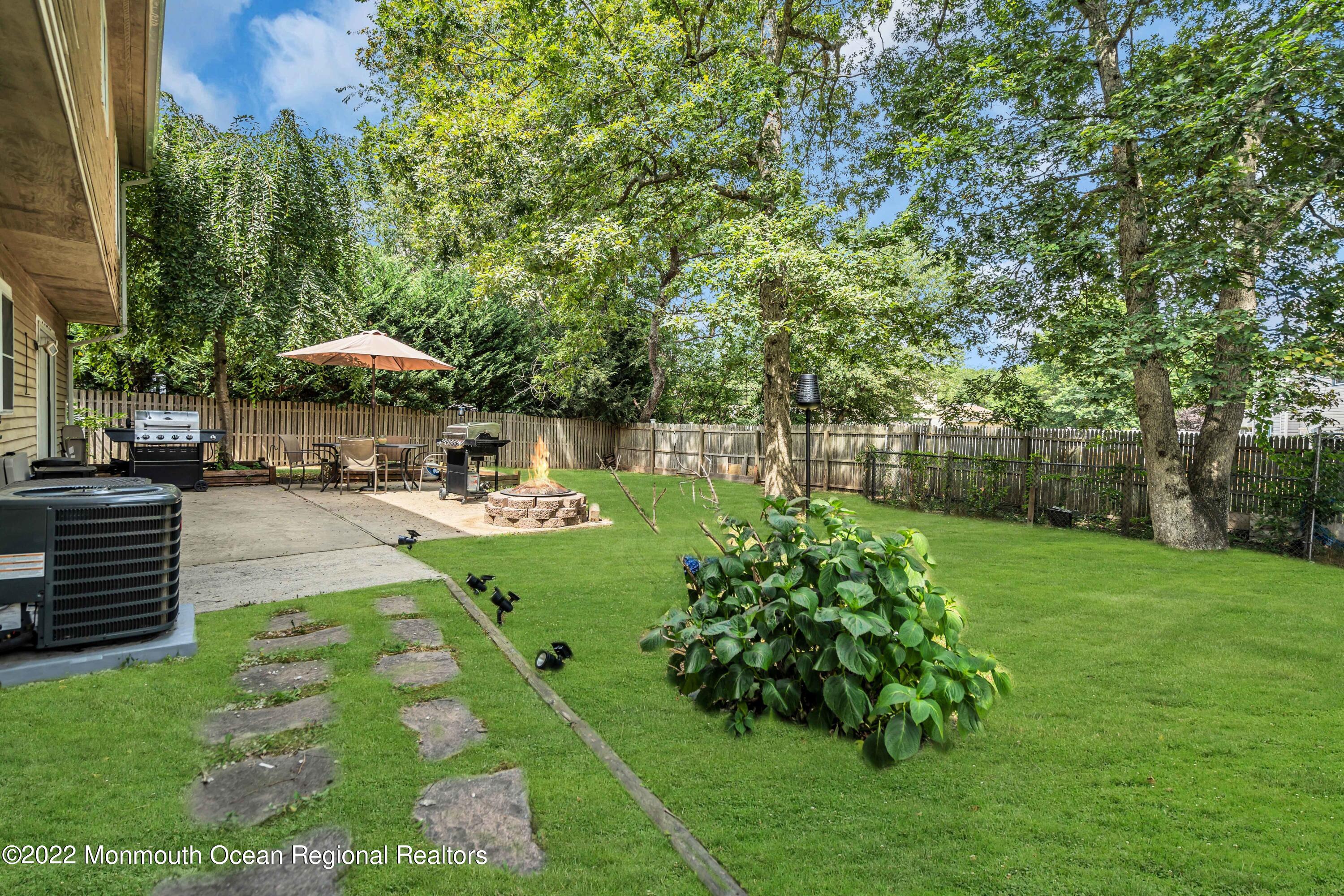 148 Weldon Road Manchester Township, NJ 08759 - Photo 32 of 36 a view of a backyard with plants and a patio
