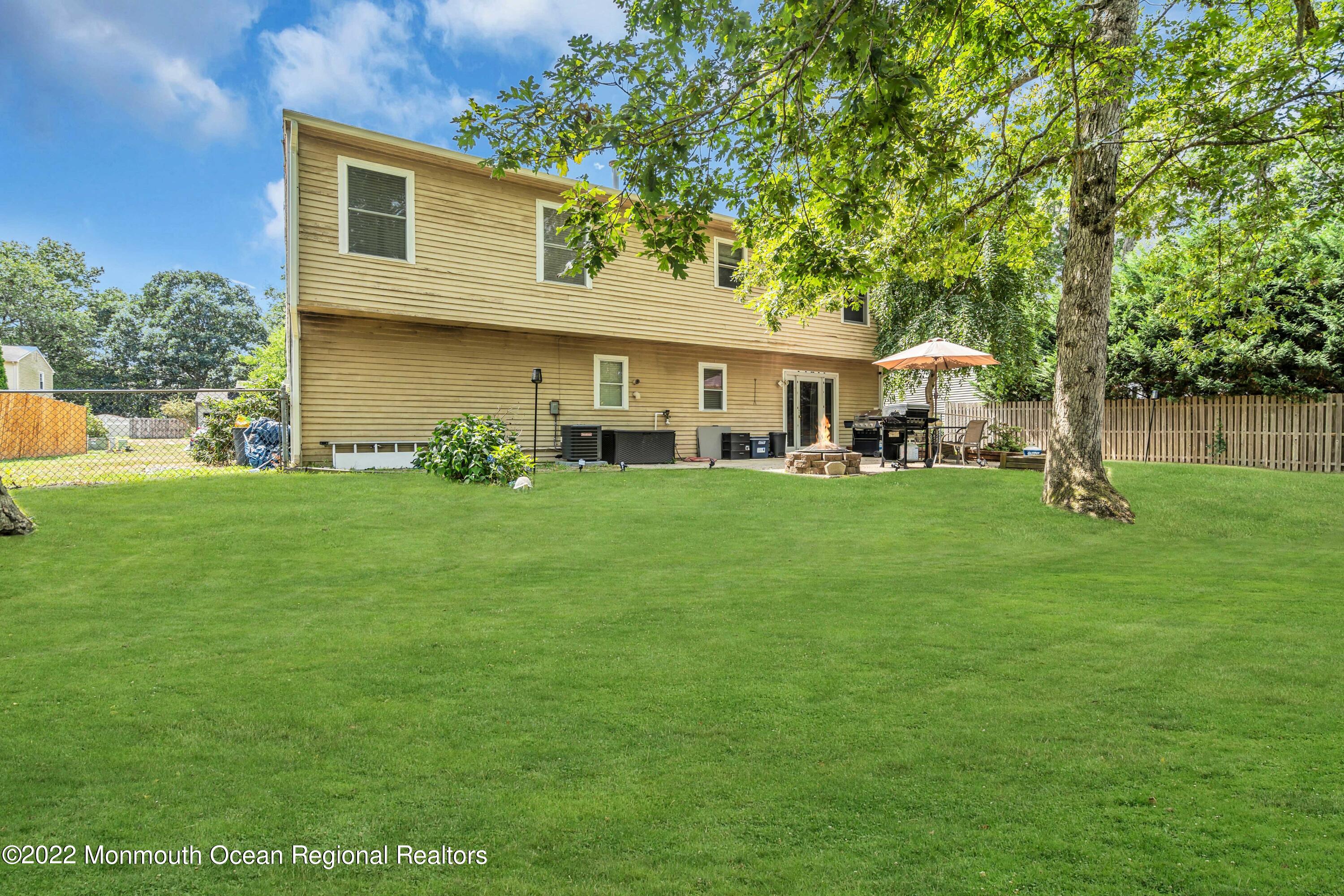 148 Weldon Road Manchester Township, NJ 08759 - Photo 34 of 36 a front view of a house with garden