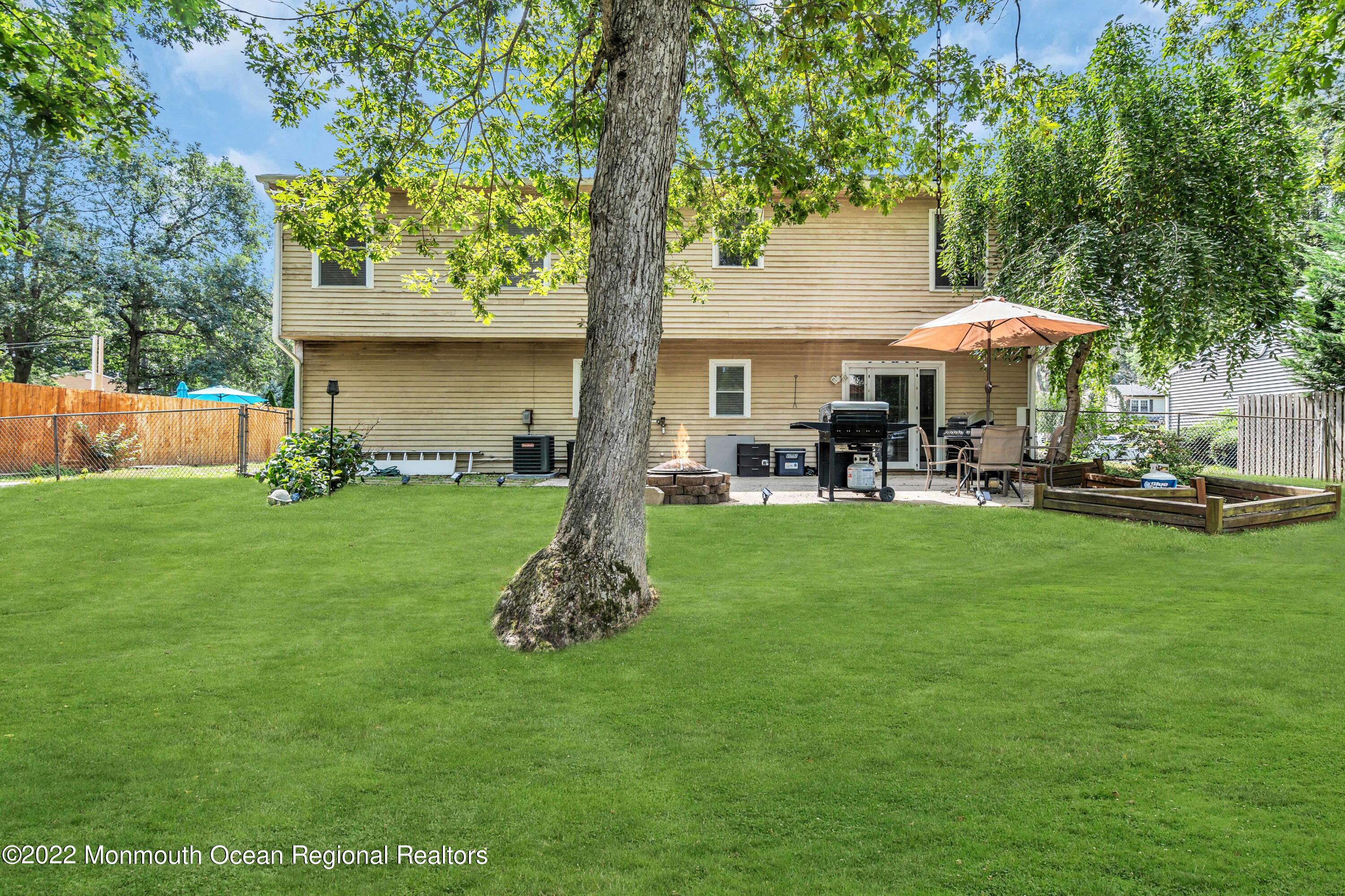 148 Weldon Road Manchester Township, NJ 08759 - Photo 35 of 36 a front view of a house with a garden and trees