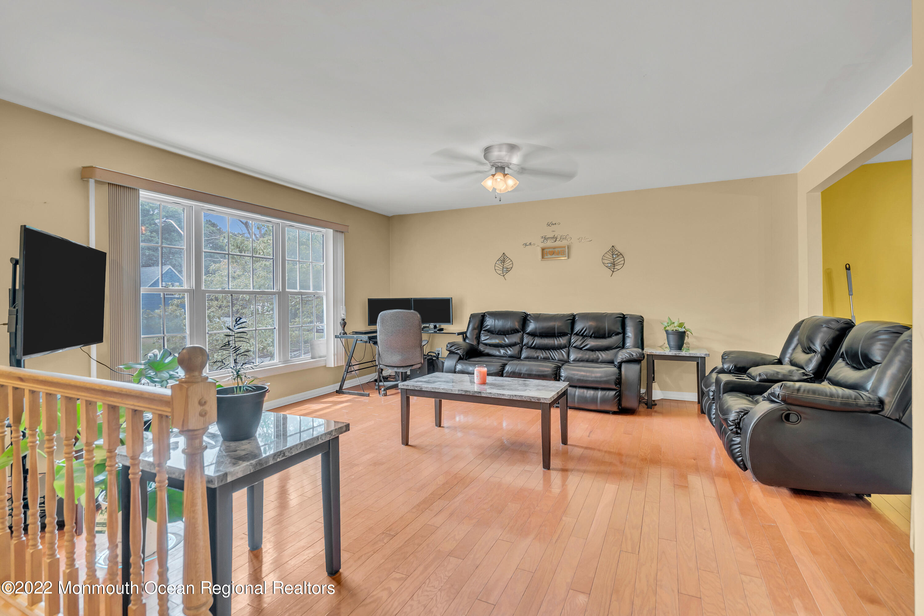 148 Weldon Road Manchester Township, NJ 08759 - Photo 9 of 36 a living room with furniture a flat screen tv and a floor to ceiling window