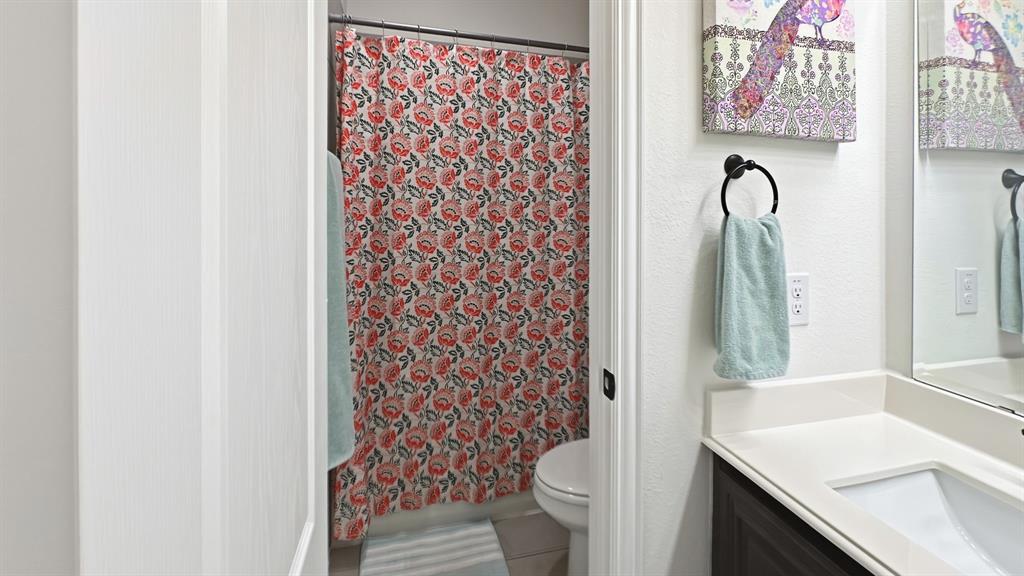5216 Troupe Road McKinney, TX 75071 - Photo 29 of 40 Bathroom featuring a built-in vanity with an undermount sink, a large mirror, and a toilet