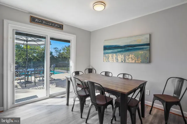 a view of a dining room with furniture wooden floor and a potted plant