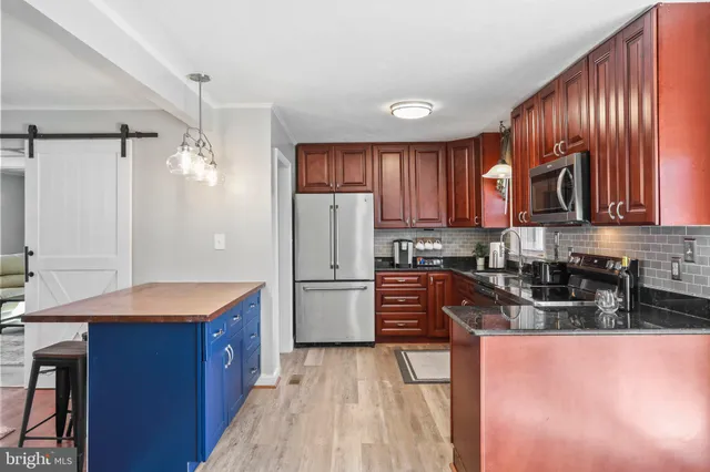 a kitchen with refrigerator cabinets and wooden floor