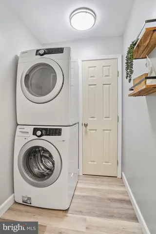a view of a kitchen area with furniture and wooden floor