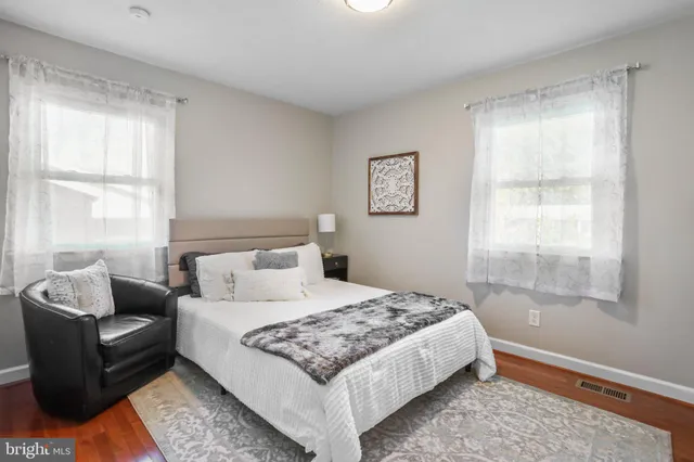 a bedroom with two beds and a window