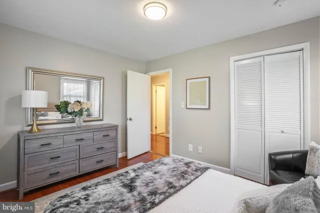 a bedroom with a bed couch and window