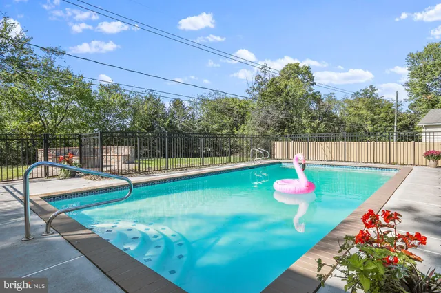 a view of a backyard with swimming pool