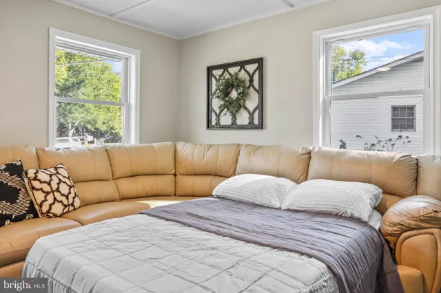 a bedroom with two beds and a couch