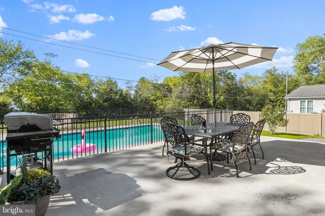 a view of a chairs and table in the back yard