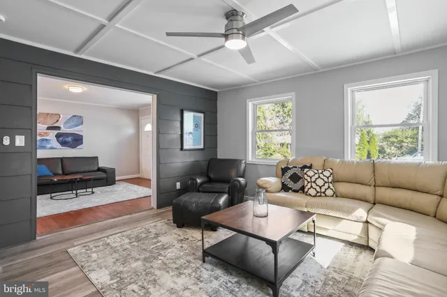 a living room with furniture a rug and a window