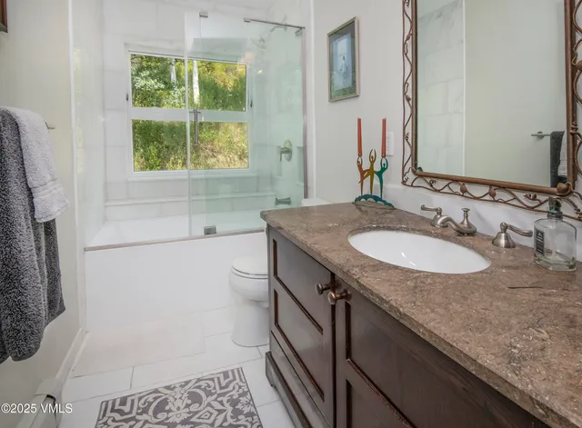 an aerial view of a house with yard and green space