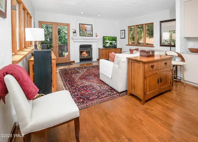 a living room with furniture a fireplace and a window