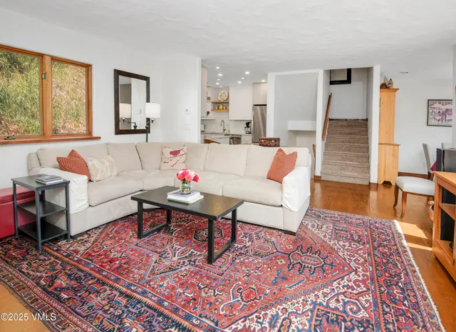 a living room with furniture and a rug