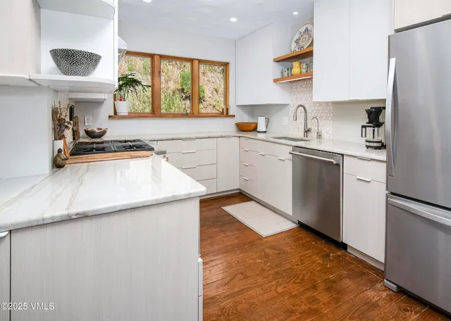 a kitchen with a sink a stove and a refrigerator
